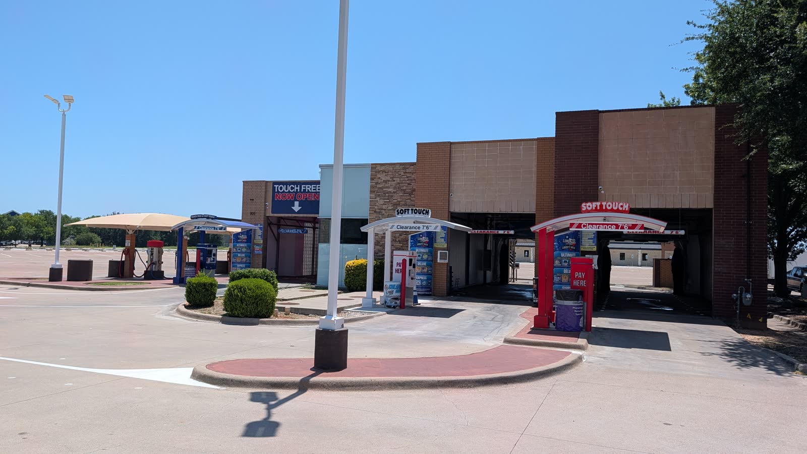 Lone Star Liberty Wash facility on US Hwy 377 in Granbury, Texas — three wash bays with self-service vacuum stalls under canopy